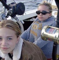 two women sitting on a boat in the water