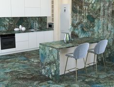 a kitchen with green marble counter tops and blue chairs in front of an island that is surrounded by white cabinets