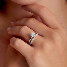 a woman's hand with a diamond ring on her finger