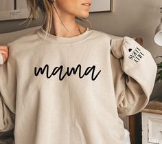 Are you looking for THE perfect gift for mother's day or for new moms? Then you are at the right place! This cozy sweatshirt will quickly become a well-loved favorite for any mother, new mom or even grandmother. You can customize the sleeve ends with up to 8 kids names. This individual touch and the little heart make the sweater even more special and loveable. Please leave the kids names in the personalization box. You should also select left or right sleeve. The sweatshirt is very soft and comf Christian Hoodies, Mom Sweater, Mom Hoodies, Personalized Grandma, Grandma Shirts, Mama Shirts, Mama Sweatshirt, Mom Sweatshirt, Mothers Day Shirts