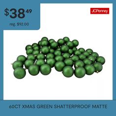 a pile of green christmas balls sitting next to each other