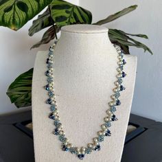 "Romantic and sparkling bridal necklace and earrings. This blue pearl and crystal necklace is beautiful for your wedding day and even for an evening event. Adorn yourself with an elegant blue statement necklace. The blue wedding necklace is beaded with blue Swarovski crystal beads, Czech white pearls, and Japanese seed beads.  ✧ 𝗠𝗘𝗔𝗦𝗨𝗥𝗘𝗠𝗘𝗡𝗧𝗦 ✧ Necklace length: 18.11\" (46cm)  ✧ 𝗨𝗽𝗴𝗿𝗮𝗱𝗲 𝘆𝗼𝘂𝗿 𝗷𝗲𝘄𝗲𝗹𝗿𝘆 𝗰𝗼𝗹𝗹𝗲𝗰𝘁𝗶𝗼𝗻 𝘄𝗶𝘁𝗵 𝘁𝗵𝗲𝘀𝗲 𝗯𝗲𝗮𝘂𝘁𝗶𝗳𝘂𝗹 𝗻𝗲𝗰𝗸𝗹𝗮𝗰𝗲 ✧ ✧ 𝗧𝗵𝗼𝘂𝗴𝗵𝘁𝗳𝘂𝗹𝗹𝘆 𝗽𝗮𝗰𝗸𝗮𝗴𝗲𝗱 𝗶𝗻 𝗮 𝗴𝗶𝗳𝘁 𝗯𝗼𝘅 ✧. For more wedding necklaces click here: https://www.etsy.com/shop/liorajewelry?section_id=18233732&ref=shopsection_leftnav_4 Back to my shop: https://www.etsy.com/shop/liorajewelry Thank you for visiting my shop!" Elegant Blue Beaded Pearl Necklace, Blue Beaded Pearl Necklace For Wedding, Blue Round Beads Pearl Necklace For Wedding, Blue Pearl Necklace With Round Beads For Wedding, Blue Pearl Drop Necklaces For Wedding, Blue Pearl Drop Necklace For Wedding, Elegant Blue Beaded Necklace With Pearl Drop, Elegant Blue Pearl Beaded Necklaces, Handmade Elegant Blue Bridal Necklace