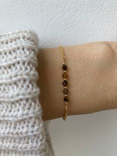 This little bracelet made with banded tiger's eye  is associated with prosperity, abundance, and attracting wealth and luck. D E T A I L S *It features 3mm faceted banded  tiger's gemstones *These are separated by seamless gold filled/sterling silver beads. *Choose between an 18k gold filled/rose gold filled or 925 sterling silver chain. *Bracelet comes with an explanatory crystal information card and care instructions and as with all our products is gift ready. S I Z I N G * H E L P This bracelet is adjustable to ensure a snug fit to avoid it rolling so size down rather than up. For example if you usually wear a 6.5 inches bracelet size down and  choose the 6 - 7.5. C A R E * T I P This is a dainty bracelet so please treat it with care. Avoid contact with water- pyrite has a high iron con Brown Gemstone Bracelet As A Gift, Brown Gemstone Bracelet Perfect For Gifts, Brown Gemstone Bracelet Gift, Brown Gemstone Bracelet For Gift, Tiger Eye Bracelet For Women, Tiger Bracelets, Crystal Information, Tiger's Eye Bracelet, Attracting Wealth