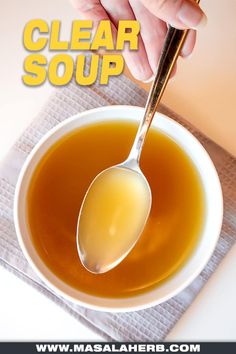 a person is holding a spoon over a bowl of soup with the words clear soup above it