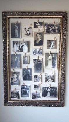 an old photo hanging on a wall with clothes pins and pictures pinned to the frame