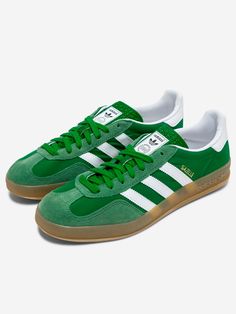 A remake of the 1979 Gazelle Indoor, the sneakers most favored by soccer fans and sneakerheads alike. A green suede upper and durable leather lining combine with a translucent rubber outsole. The 3 stripes and metallic lettering complete the iconic look.   Suede upper  Lace-up closure  Leather lining  Rubber sole  Green / Cloud White / Hazy Green   Size & Fit: Fit regular Adidas Gazelle Indoor, Adidas Originals Gazelle, Trendy Bracelets, Soccer Fans, Cloud White, Boot Pumps, Green Suede, Adidas Gazelle, Elegant Necklaces