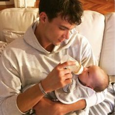 a man holding a baby in his arms