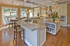 a large kitchen with an island in the middle and lots of counter space on each side