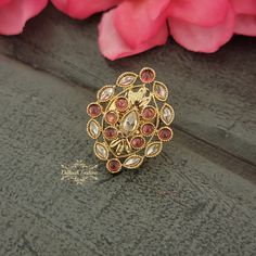 "Beautiful handcrafted gold polki ring with a pop of color - adjustable size. Ring Shape: Oval Eye The ring is approximately 1.35 \" long & 1.1 \" wide. Picture is taken in natural room light. Please contact if you have any questions. Thanks! Color, shades, texture displayed may slightly vary from the actual product due to digital image limitations. We request you to consider these minor variations. Please expect the possibility of some slight imperfections when buying hand made jewelry. If you Gold Kundan Toe Ring, Festive Toe Rings For Gifts, Gold Rings For Festive Celebrations, Gold Rings For Celebrations And Festive Occasions, Festive Gold Rings For Celebration, Kundan Toe Ring As Gift, Indian Ring, Natural Room, Indian Rings