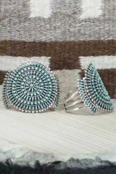 This Kingman turquoise and sterling silver necklace, earrings, bracelets, and rings set was made by Zuni silversmith Merlinda Chavez. The back of the necklace is signed D & M Chavez and Zuni.Necklace: 30"Length: 3 1/2"Width: 2 1/2"Earrings:Length: 1 3/4"Width: 1 3/4"Bracelets:Size: 5 3/4" (will fit up to a 7 1/8" wrist)Gap: 1 3/8"Length: 2 5/8"Rings:Size: 9.25 & 9.5Length: 1 3/4"Width: 1 3/4"Free shipping on all orders! We ship with USPS and always include tracking. All orders ship within a day Bracelets And Rings, Silver Jewelry Set, 2 Earrings, Silver Jewellery Sets, Rings Set, Kingman Turquoise, Native American Jewelry, Sterling Silver Necklace, Turquoise Sterling Silver