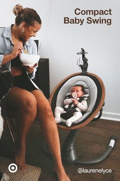 a woman feeding her baby while sitting in a swing