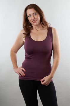 a woman is posing for the camera with her hands on her hips