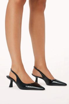 Ayla by Billini is a cross between a pointed pump and a kitten heel. This ultra-luxe style is the perfect day-to-night look! Featuring a low kicked in stiletto heel, simple court style upper, sling back strap with elasticated gusset, and an exposed heel counter. Available in black and bone patent. Pair with a chic mini dress for the perfect night out look! Details low heel Closed pointed toe Slip on design Synthetic patent upper, lining, and outsole Fit & Sizing This style is a regular fit. We s Black Ball Dress, Short Stiletto, Black Patent Heels, Pointed Pumps, School Fit, Luxe Style, Patent Heels, Perfect Night, Pointed Toe Heels