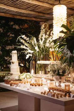 a table topped with lots of cake and flowers