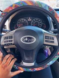 the steering wheel cover is decorated with colorful designs