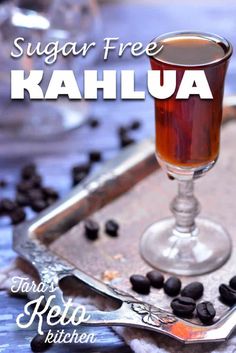 sugar free kahlua in a glass on a tray with coffee beans