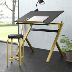 a black and yellow desk with a lamp on it