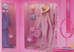 a pink room with two mannequins in it