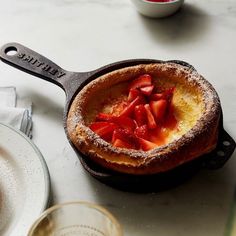 a cast iron skillet filled with food on top of a table