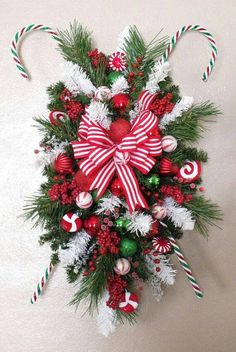 a christmas wreath with candy canes and decorations