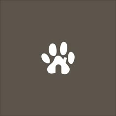 an animal's paw is shown in white on a brown background, with the letter h