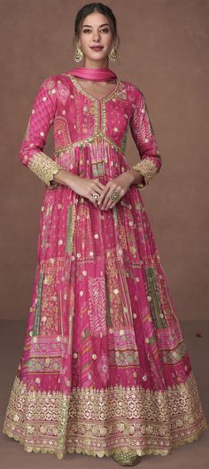 a woman in a pink gown with gold accents and an intricate pattern on the skirt