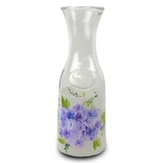 a glass vase with purple flowers painted on it