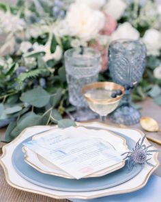 an elegant table setting with blue and white plates