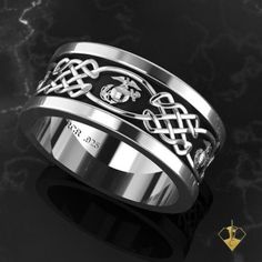 a white gold ring with celtic designs on it