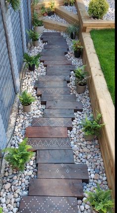 a garden path made out of stones and wood