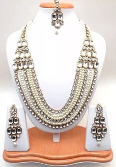 "Handmade Indian Jewelry Rani haar Necklace Set With Pearl imitation , Czech , Gold Plated indian Jewellery Type :Rani Haar Necklace Set Necklace Length: 10\"inches Approx + Adjustable Necklace Thread. Earrings Length: 2.8\"inches Approx Shape - As Shown in Picture It is a perfect match with formal attire on special occasions or with casual wearing The item will come with the clear plastic box or plastic bag and packaging Traditional Indian Wedding Jewellery Slight Colour variations possible due to difference in screen and photograph Care instructions Keep Jewellery away from direct heat, water, perfumes, deodorants and other strong chemicals as they may react with the metal or plating. The plating composition of Jewellery is as such that perspiration (sweat) will not damage it. Wipe Jewel White Kundan Bohemian Jewelry, Bollywood Style Jewelry With Mirror Work For Puja, Bollywood Jewelry With Mirror Work For Puja, Bohemian Mala For Wedding And Festivals, Festive White Bohemian Jewelry Sets, Elegant Mirror Work Jewelry For Puja, Elegant Jewelry With Mirror Work For Puja, Bohemian White Jewelry With Stone Work, White Bohemian Kundan Necklace