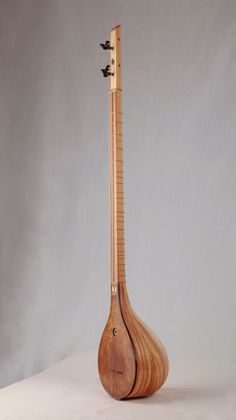 a wooden instrument sitting on top of a white table