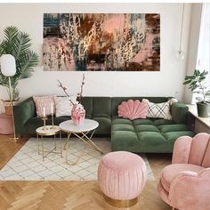 a living room filled with pink and green furniture