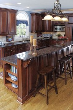 a kitchen with wooden cabinets and an island