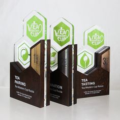 three tea tasting awards sitting on top of each other