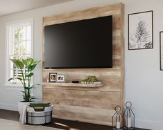 a flat screen tv mounted to the side of a wooden wall in a living room