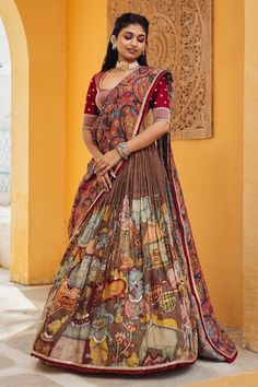 Brown attached cancan lehenga with ganesha and cows kalamkari hand painted patterns. Paired with padded maroon embroidered blouse and pink printed dupatta. - Aza Fashions Unstitched Anarkali Set With Kalamkari Print For Wedding, Unstitched Kalamkari Wedding Choli, Unstitched Wedding Choli With Kalamkari Print, Designer Wear Sharara With Kalamkari Print In Traditional Drape, Designer Wear Sharara With Kalamkari Print, Bollywood Style Kalamkari Print Sharara For Wedding, Designer Chanderi Sharara With Kalamkari Print, Wedding Anarkali Set With Kalamkari Print, Wedding Lehenga With Kalamkari Print In Traditional Drape