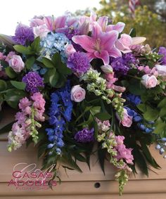 a bunch of flowers that are sitting on a bench