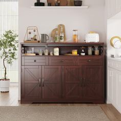 a kitchen with white walls and wooden cabinets in the center, along with an area rug on the floor