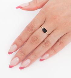 Jennie Kwon cleverly blurs the line between statement piece and everyday adornment with this high-contrast ring. A sideway-set onyx gets paired with six tiny white diamonds for a big vs. small, black vs. white contrast that manages to be both super impressive and super wearable. Wear it on your pointer or middle finger with several stacked bands nearby for a picture perfect combo. Made in the U.S.A. 14 karat gold with one 7 mm x 5 mm emerald-cut onyx and six 1 mm white round diamond accents. Modern Black Emerald Cut Jewelry, Minimalist Black Emerald Cut Jewelry, Minimalist Black Jewelry With Single Diamond, Elegant Onyx Rings For Everyday Wear, Black Fine Jewelry Rings For Everyday, Everyday Black Fine Jewelry Ring, Everyday Fine Black Ring, Black Ring With Single Diamond In Fine Jewelry Style, Black Ring With Single Diamond