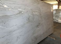 white marble is stacked up in a warehouse