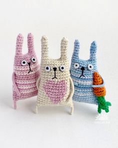 three crocheted rabbits with carrots in their mouths