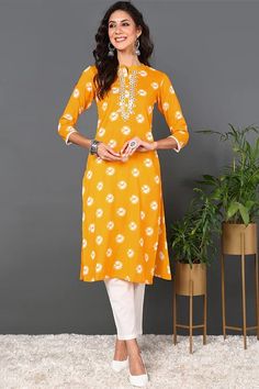 This yellow cotton embroidered ethnic motifs straight kurta is a beautiful and versatile piece that can be dressed up or down. It is perfect for both formal and casual occasions. The kurta is made of a soft and comfortable cotton fabric, and it features a flattering straight silhouette. The ethnic motifs are embroidered in a contrasting shade of yellow, and they add a touch of elegance to the kurta. Size & FitThe model (height 5'8) is wearing a size S Material & CareTop Fabric :- Cotton Wash Care :- Hand Wash SpecificationsSleeve Length :- Three-Quarter SleevesSleeve Styling :- Regular SleevesShape :- StraightDesign Styling :- EmpireHemline :- FlaredLength :- Calf LengthNeck :- Round NeckPrint or Pattern Type :- GeometricOccasion :- FestiveWeave Pattern :- RegularWeave Type :- Machine Weav Spring Orange Straight Kurta, Yellow Traditional Wear With Straight Kurta And Floral Embroidery, Orange Kurta With Printed Motifs For Diwali, Yellow Traditional Wear With Floral Embroidery And Straight Kurta, Summer Orange Kurta With Printed Motifs, Diwali Orange Kurta With Printed Motifs, Orange Printed Motifs Kurta For Navratri, Orange Kurta With Printed Motifs For Navratri, Orange Printed Kurta For Navratri