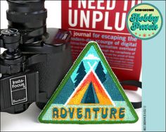 an image of a camera and some other items on a white surface with the words adventure written below it