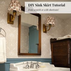 a bathroom sink sitting under a mirror next to a wooden cabinet and light above it