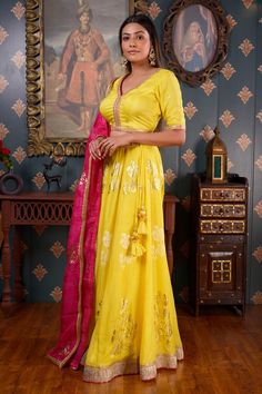 Lemon yellow lehenga with foil printed floral motifs and gota patti border. Comes with V neck blouse with lace trim and rani pink dupatta.
Component: 3
Pattern: Print and Embroidery
Type Of Work: Foil Print, Gota Patti and Sequin
Neckline: V neck
Sleeve Type: Half
Fabric: Cotton Silk
Color: Yellow
Other Details: 
Rani pink dupatta with floral motifs and lace trim border
Sequin embroidered waistband
Tie up with tassels on the sides
Occasion: Sangeet - Aza Fashions Lemon Yellow Lehenga, V Neck Lehenga, Pink Dupatta, Rani Pink, Yellow Lehenga, Silk Lehenga, V Neck Blouse, Lemon Yellow, Floral Motifs