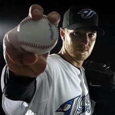 a man holding a baseball in his right hand