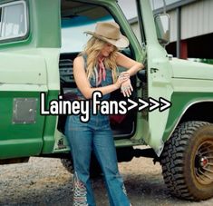 a woman standing next to a green truck with the words laney fans on it