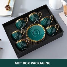 the gift box is filled with tea cups and saucers