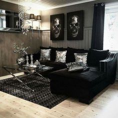 a living room with couches, tables and pictures on the wall in it's corner